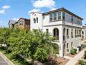 Charming two-story home with a white stucco exterior, decorative archways and well maintained front yard at 1679 E Dogwood Ln, Gilbert, AZ 85295