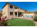 Spacious backyard with artificial turf, pool, outdoor seating, and basketball hoop at 17005 S Coleman St, Phoenix, AZ 85045
