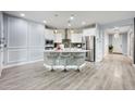 Open concept kitchen with island, white cabinets, stainless steel appliances, and pendant lighting at 17545 W Lilac St, Goodyear, AZ 85338