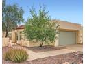 Beige home with terra cotta roof, manicured landscaping and an attached two-car garage at 2167 E Aspen Dr, Tempe, AZ 85282