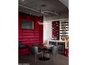 Unique dining space featuring a red velvet bench, a wine rack, and contemporary lighting at 2211 E Camelback Rd # 605, Phoenix, AZ 85016