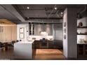 Contemporary kitchen with stainless steel appliances, custom cabinetry, and a large central island at 2211 E Camelback Rd # 605, Phoenix, AZ 85016