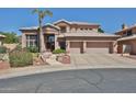 Charming two-story home featuring a tile roof, mature trees, and well-manicured front yard at 22521 N 60Th Ave, Glendale, AZ 85310