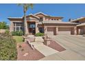 Beautiful home featuring a tile roof, mature trees, and a three-car garage with a wide driveway at 22521 N 60Th Ave, Glendale, AZ 85310