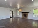 Open living area featuring a brick fireplace and abundant natural light at 2904 W Belmont Ave, Phoenix, AZ 85051