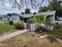 Inviting single-story home with a tidy front yard, desert landscaping, and a charming, gated walkway at 2945 N 19Th Ave # 78, Phoenix, AZ 85015