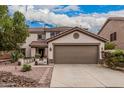 Charming two-story home featuring a large two-car garage and a well-maintained front yard at 3135 W Molly Ln, Phoenix, AZ 85083