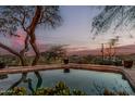 Scenic swimming pool with serene water reflecting the evening twilight in a private backyard setting, perfect for relaxation at 3201 N 91St St, Mesa, AZ 85207