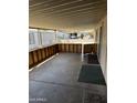 Covered back porch with wood-look fencing and a view of a nearby car at 3330 E Main St # 332, Mesa, AZ 85213