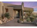 Inviting front entrance with desert landscaping, featuring rocks, cacti, and native plants at 41823 N 111Th Pl, Scottsdale, AZ 85262