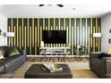 Stylish living room featuring a modern accent wall and comfortable seating at 4617 E La Puente Ave, Phoenix, AZ 85044