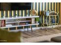 Close-up of media console, bar cart and accent wall in a modern living room at 4617 E La Puente Ave, Phoenix, AZ 85044