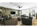 Bright living room with wood floors, an accent wall, and ample seating at 4617 E La Puente Ave, Phoenix, AZ 85044