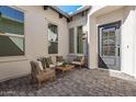 A private brick courtyard is styled with a loveseat, chairs and a wooden table at 5747 E Star Valley St, Mesa, AZ 85215