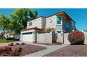 Charming two-story home with a two-car garage and well-manicured front yard at 6720 W Mcrae Way, Glendale, AZ 85308