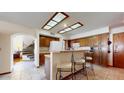 Bright kitchen featuring ample cabinet space, tile flooring and adjacent breakfast bar at 6720 W Mcrae Way, Glendale, AZ 85308