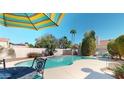 Beautiful backyard pool area surrounded by mature trees and plenty of space for outdoor entertaining at 6720 W Mcrae Way, Glendale, AZ 85308