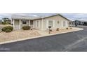 Inviting single-story home with a well-maintained yard and a quaint front porch at 890 E Tee St, San Tan Valley, AZ 85140