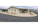 Charming single-story home with desert landscaping and a convenient covered parking space at 890 E Tee St, San Tan Valley, AZ 85140