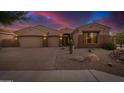 Attractive desert home featuring a three-car garage and manicured gravel landscaping at 9604 S 183Rd Dr, Goodyear, AZ 85338