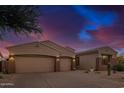 Attractive desert home featuring a three-car garage and manicured gravel landscaping at 9604 S 183Rd Dr, Goodyear, AZ 85338
