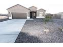 Charming single-story home with desert landscaping and a two-car garage at 10005 W Mission Dr, Arizona City, AZ 85123
