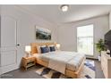 Cozy bedroom with a comfortable bed, stylish decor, and plenty of natural light from the window at 10162 E Theorem Dr, Mesa, AZ 85212