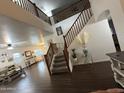 Stunning entryway with soaring ceilings, a wooden staircase, and views into the living spaces at 11219 N 165Th Ave, Surprise, AZ 85388