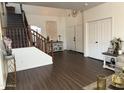 Inviting entryway featuring stylish flooring, a staircase, and a convenient coat closet at 11219 N 165Th Ave, Surprise, AZ 85388