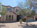 Inviting home featuring desert landscaping, a two-car garage, and neutral stucco at 11219 N 165Th Ave, Surprise, AZ 85388