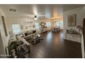 Open-concept living room and dining area featuring updated flooring, ample natural light, and stylish decor at 11219 N 165Th Ave, Surprise, AZ 85388