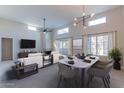 Bright and airy living room with neutral tones, fireplace, modern lighting, and dining area at 11333 N 92Nd St # 2080, Scottsdale, AZ 85260