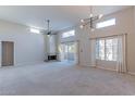 Spacious living room featuring vaulted ceilings, a fireplace, and large windows at 11333 N 92Nd St # 2080, Scottsdale, AZ 85260