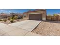 Welcoming single-story home featuring a two-car garage, desert landscaping, and a spacious driveway at 1178 E Tyler Ln, Casa Grande, AZ 85122