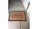 Welcoming entryway with a 'Welcome' mat and tile flooring at 12123 W Bell Rd # 118, Surprise, AZ 85378