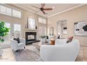 Bright living room features fireplace, high ceilings, plantation shutters, and comfortable white seating at 12625 N Saguaro Blvd # 203, Fountain Hills, AZ 85268