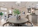 Open-concept living space with fireplace, bright natural light, and view of kitchen at 12625 N Saguaro Blvd # 203, Fountain Hills, AZ 85268