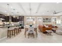 Open-concept living space featuring tile floors, modern lighting, and a seamless flow for entertaining and relaxation at 14906 W Luna N Dr, Litchfield Park, AZ 85340