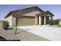 Single-story home boasts a two-car garage, low-maintenance desert landscaping and a covered front porch at 16010 S Elizabeth Pl, Arizona City, AZ 85123