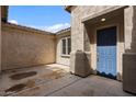 Private outdoor patio featuring a blue door, stucco walls, and covered porch at 19372 E Timberline Rd, Queen Creek, AZ 85142