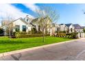 Exterior view of a beautiful two-story home with manicured lawn and landscaping, offering inviting curb appeal at 20690 E Sunset Dr, Queen Creek, AZ 85142