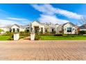 Stunning exterior showcasing brick entry, lush landscaping, and well-maintained lawn, creating an inviting entrance at 20690 E Sunset Dr, Queen Creek, AZ 85142