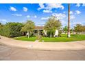 Charming single-story home featuring a lush green lawn, mature trees, and a welcoming facade at 3126 N 17Th Dr, Phoenix, AZ 85015
