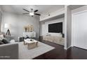 Bright living room with dark wood floors, modern furniture, and a large flat screen television at 3302 N 7Th St # 108, Phoenix, AZ 85014