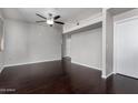 Spacious living room boasts dark hardwood floors and modern ceiling fan for comfortable living at 3302 N 7Th St # 108, Phoenix, AZ 85014