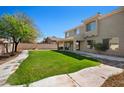 Well-maintained backyard with lush green grass and mature trees, perfect for outdoor entertaining at 4330 W Aracely Dr, New River, AZ 85087