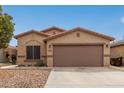 Charming single-story home with desert landscaping and two-car garage at 44865 W Miraflores St, Maricopa, AZ 85139