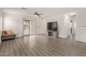 Bright living room features modern flooring and access to backyard at 44865 W Miraflores St, Maricopa, AZ 85139