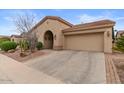 Beautiful home exterior with a desert landscape, attached garage and wide driveway at 4515 E Rakestraw Ln, Gilbert, AZ 85298