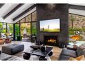 Bright living room boasts floor-to-ceiling windows, sleek fireplace, and stylish decor at 5040 N Arcadia Dr, Phoenix, AZ 85018